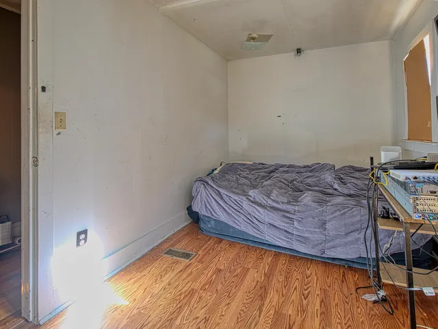 a bedroom with a bed and a window