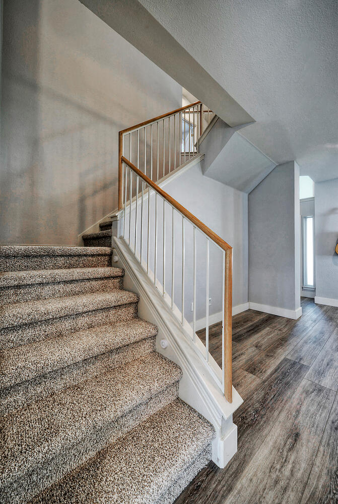 4518 Tello Path Austin, TX 78749 - Photo 12 of 26 Stairs with wood finished floors and a textured ceiling