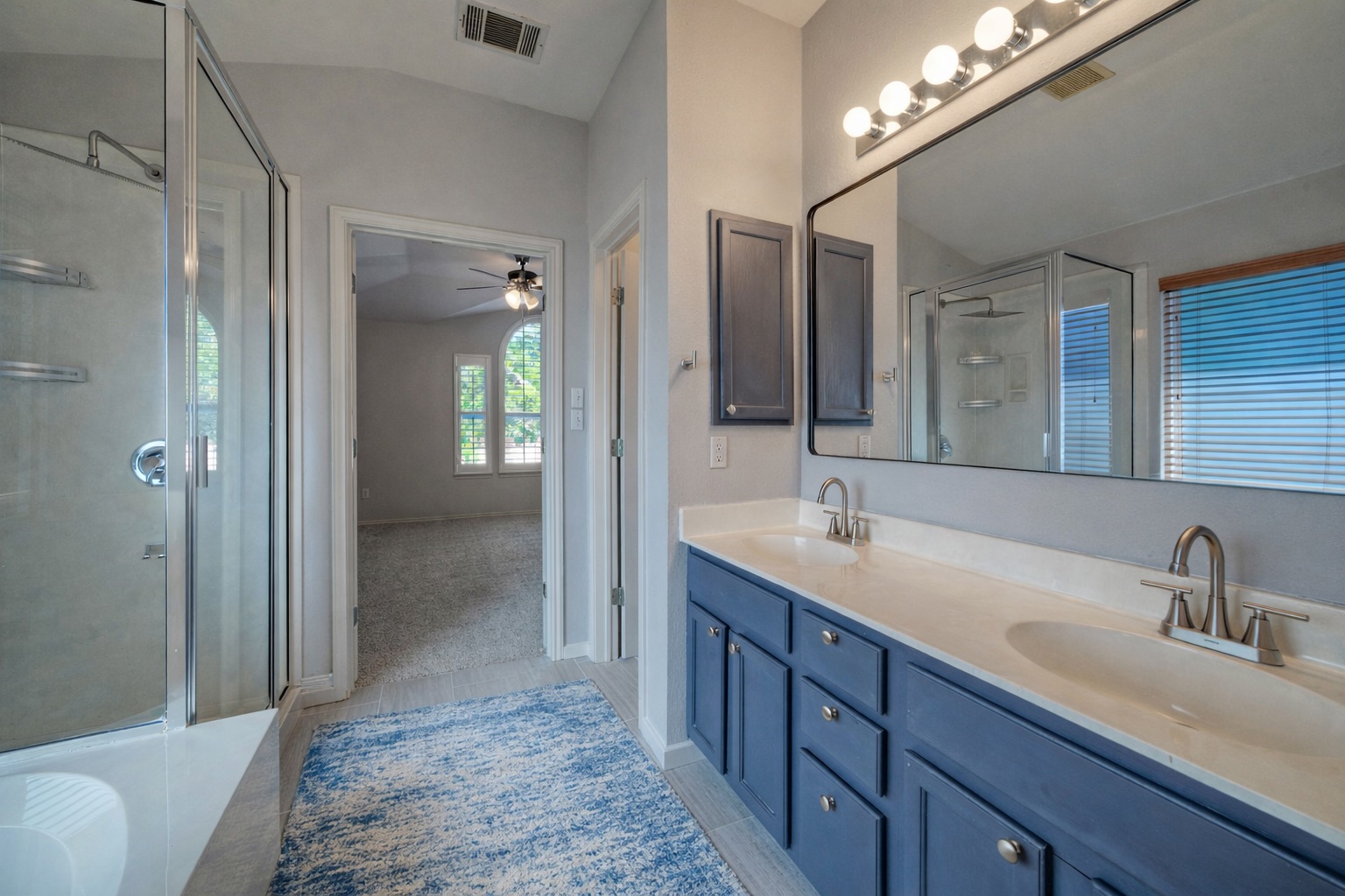 4518 Tello Path Austin, TX 78749 - Photo 15 of 26 Bathroom featuring double vanity, a stall shower, a tub to relax in, and ceiling fan