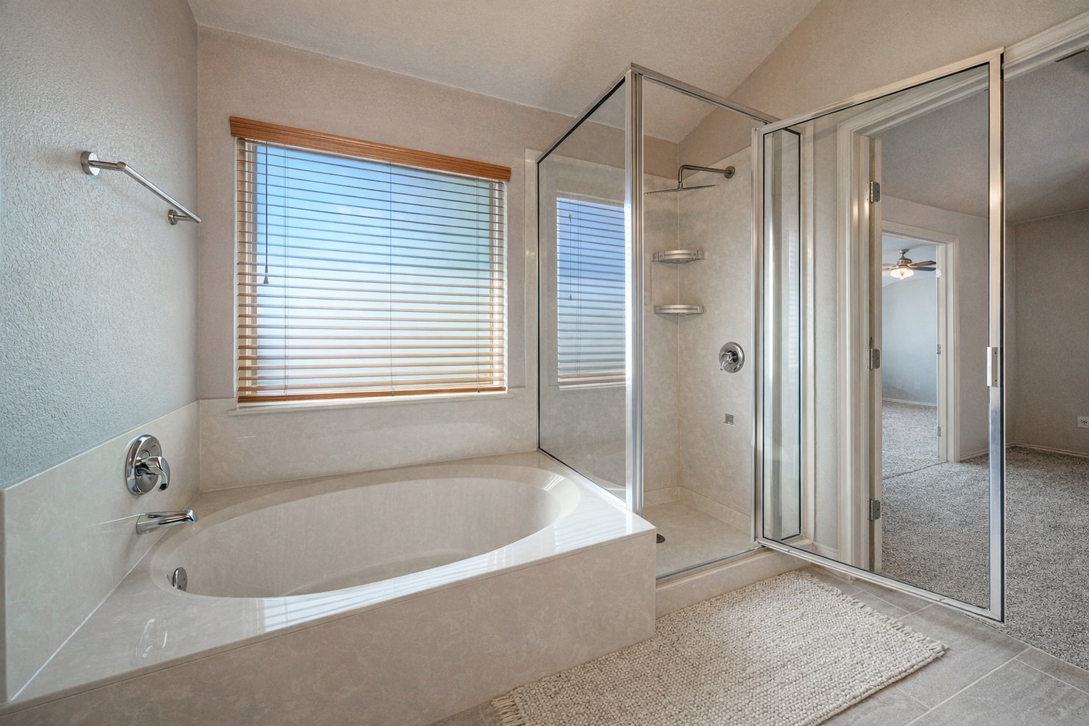 4518 Tello Path Austin, TX 78749 - Photo 16 of 26 Bathroom featuring a shower stall, a bath, a textured wall, light tile patterned floors, and a ceiling fan