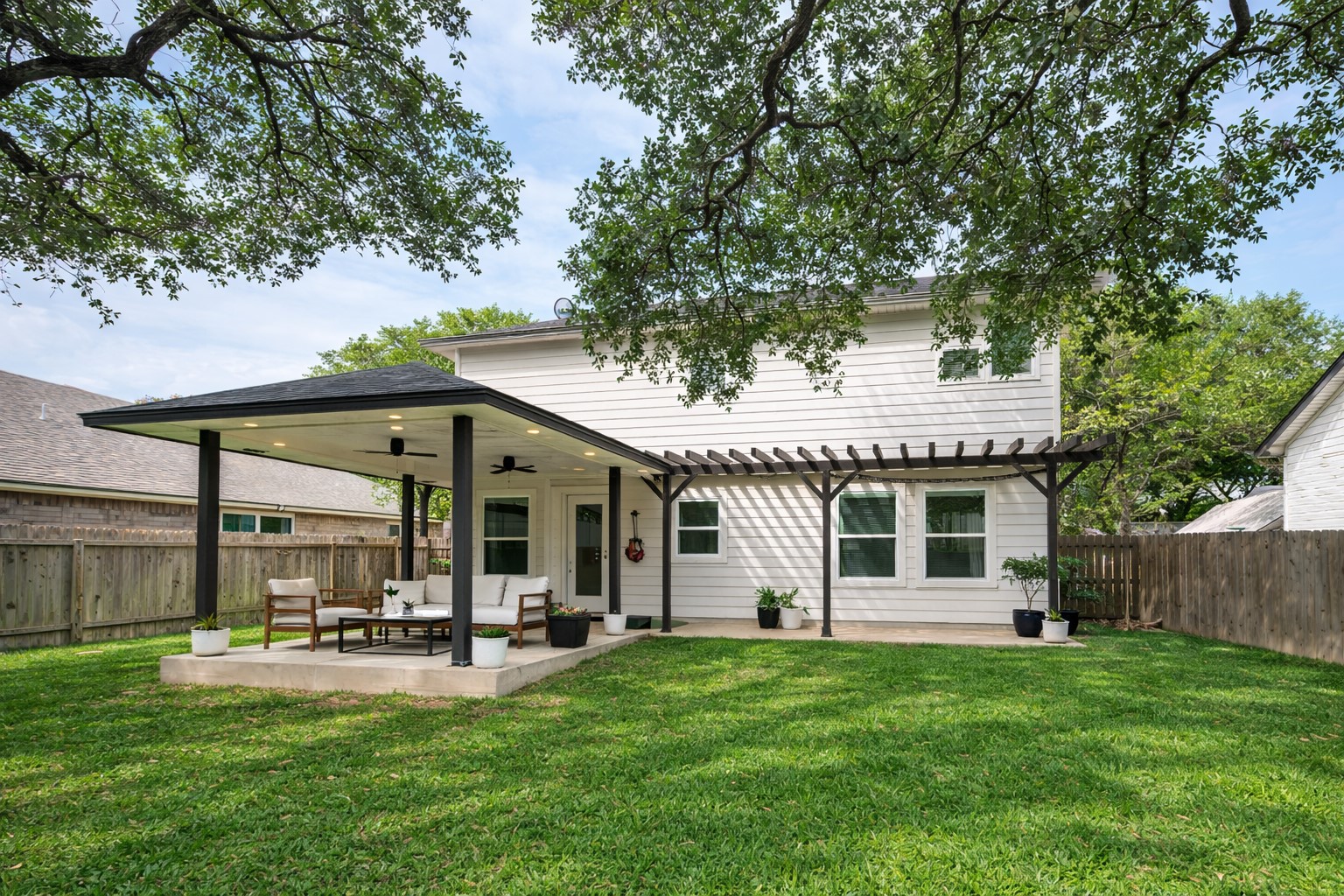 4518 Tello Path Austin, TX 78749 - Photo 21 of 26 Back of house with a fenced backyard, a patio area, ceiling fan, a pergola, and outdoor furniture