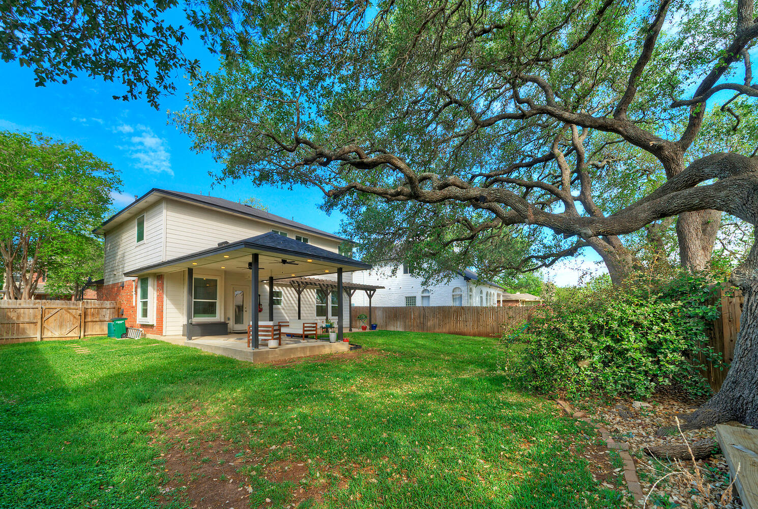 4518 Tello Path Austin, TX 78749 - Photo 25 of 26 Back of house with a patio, a fenced backyard, ceiling fan, and brick siding