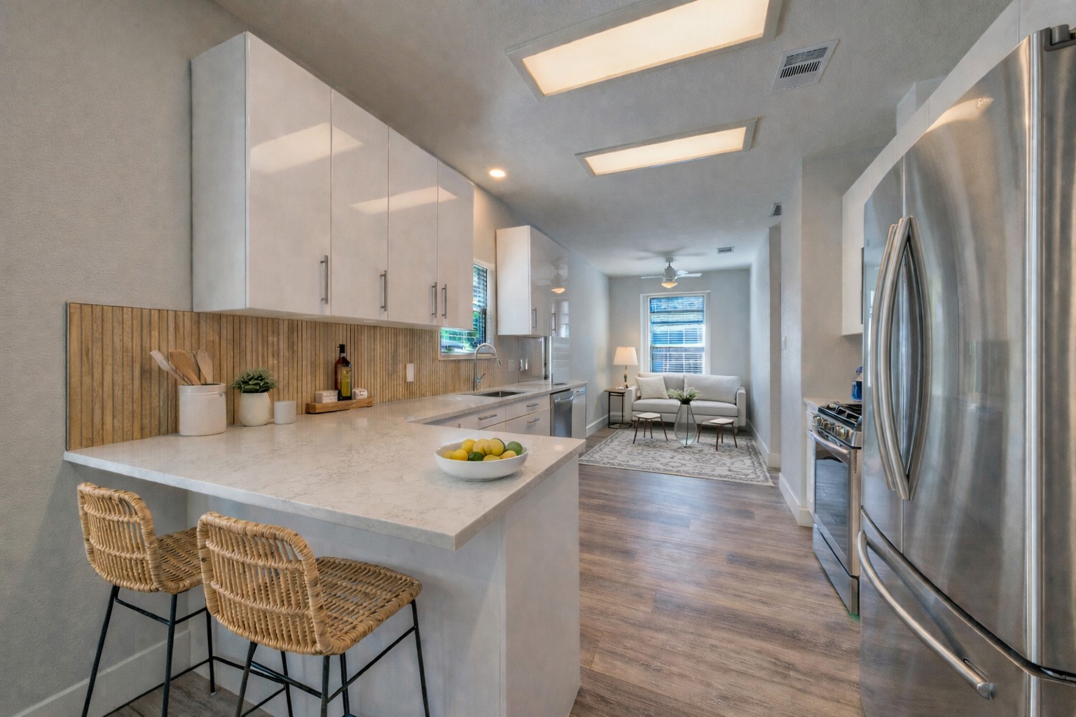 4518 Tello Path Austin, TX 78749 - Photo 7 of 26 Ai - Kitchen featuring stainless steel appliances, a breakfast bar area, white cabinetry, a peninsula, and tasteful backsplash