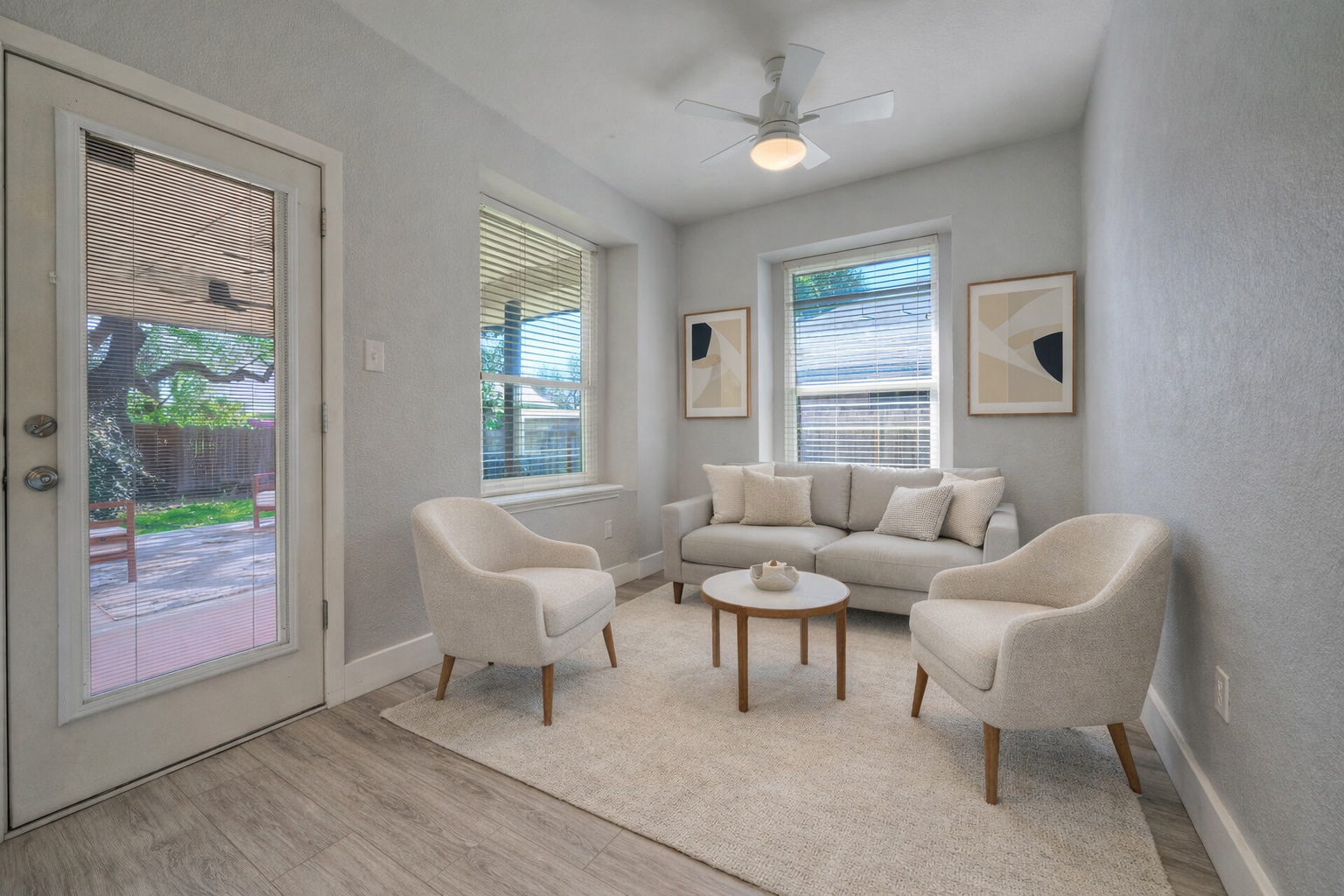 4518 Tello Path Austin, TX 78749 - Photo 9 of 26 Ai - Living area off the kitchen featuring a ceiling fan, light wood-style flooring, and a textured wall