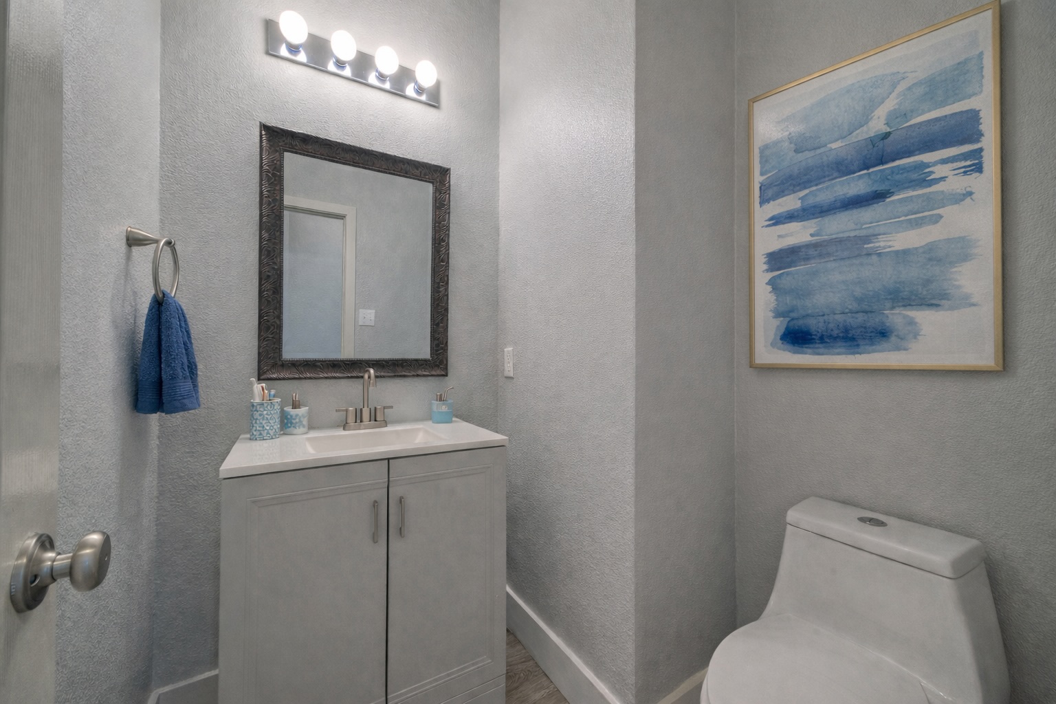 4518 Tello Path Austin, TX 78749 - Photo 10 of 26 Main Level Half bathroom featuring a textured wall, vanity, and wood finished floors