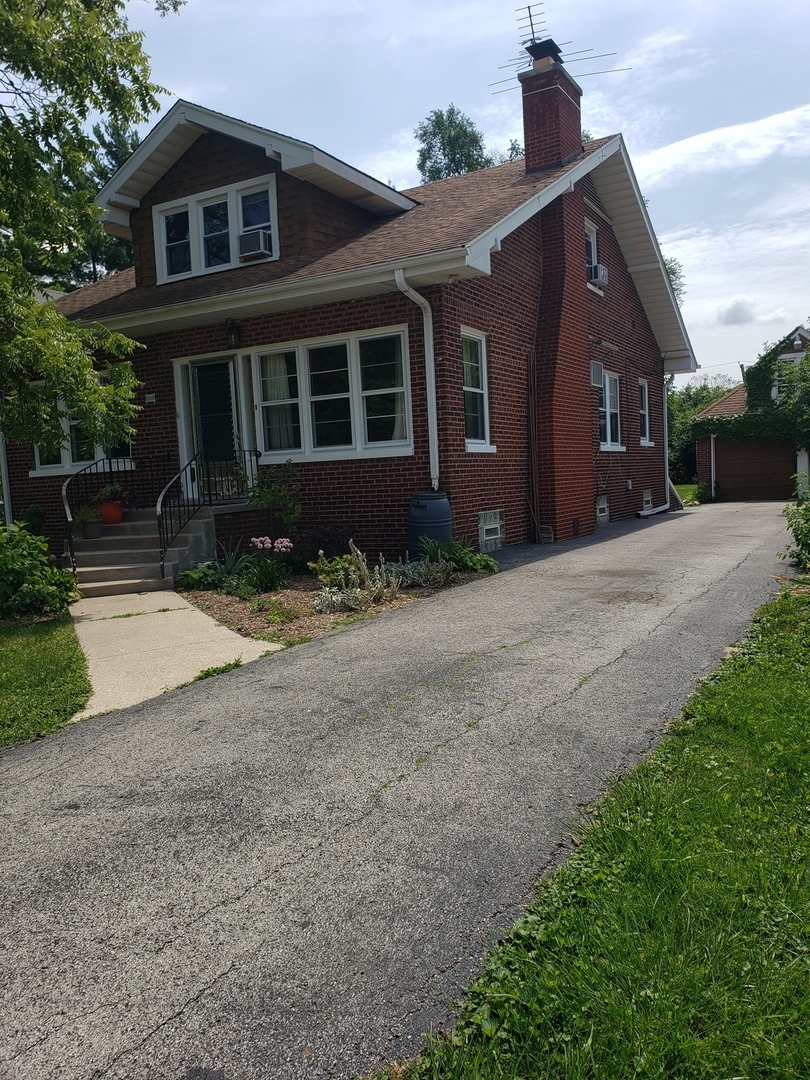 1917 Cedar Road Homewood, IL 60430 - Photo 2 of 20 a front view of a house with a yard