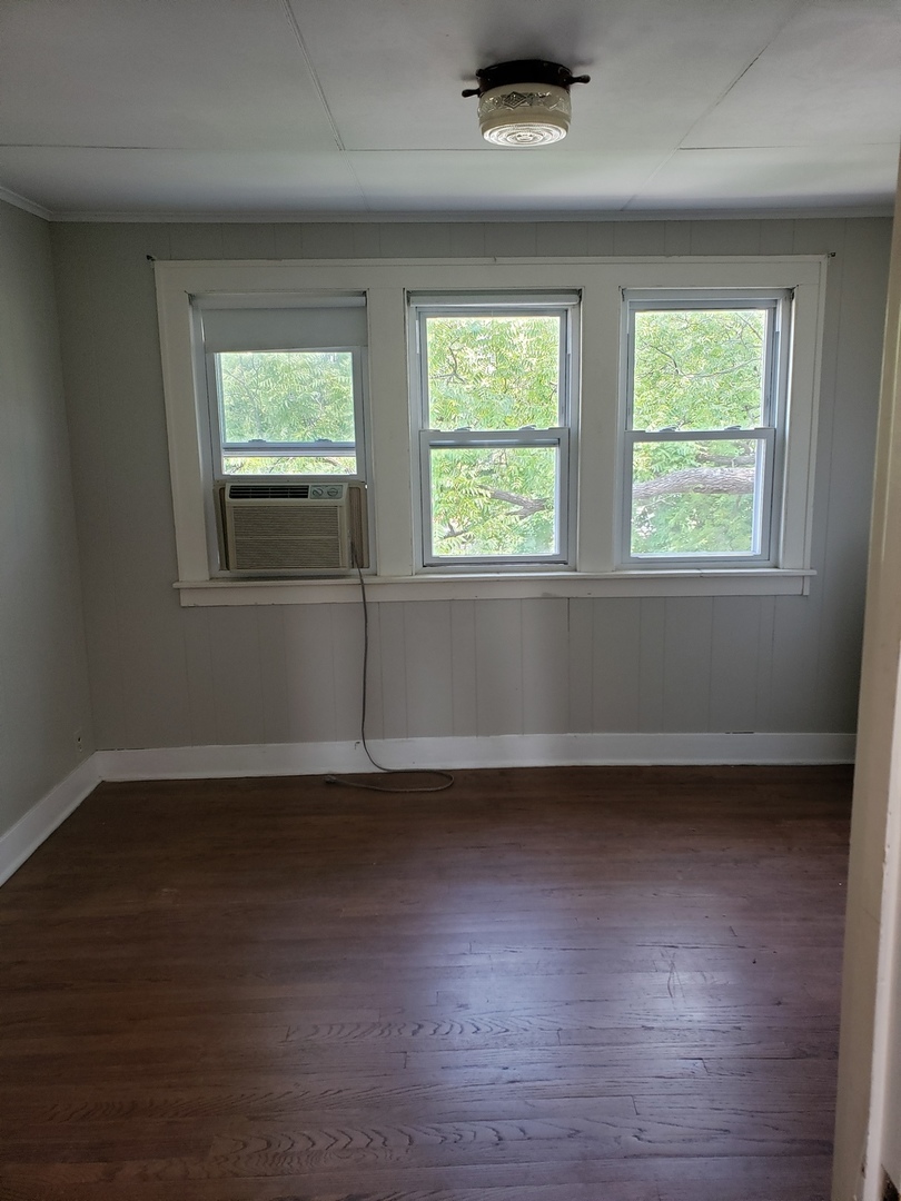 1917 Cedar Road Homewood, IL 60430 - Photo 15 of 20 an empty room with wooden floor and windows