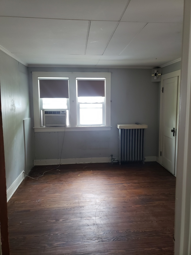 1917 Cedar Road Homewood, IL 60430 - Photo 16 of 20 an empty room with wooden floor and windows