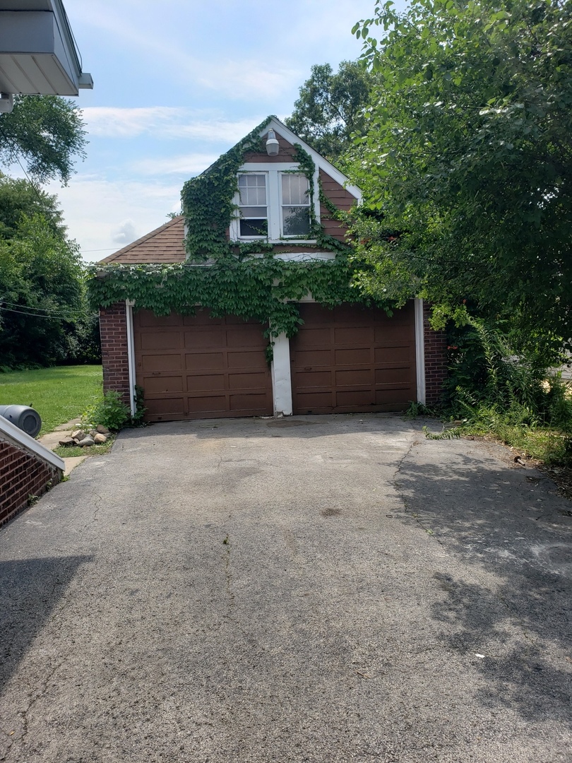 1917 Cedar Road Homewood, IL 60430 - Photo 19 of 20 a front view of a house with a yard and garage