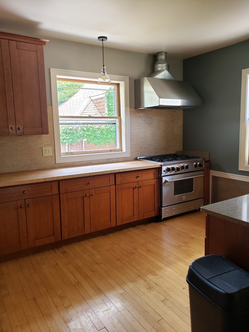 1917 Cedar Road Homewood, IL 60430 - Photo 6 of 20 a kitchen with stainless steel appliances granite countertop a stove a sink and a microwave