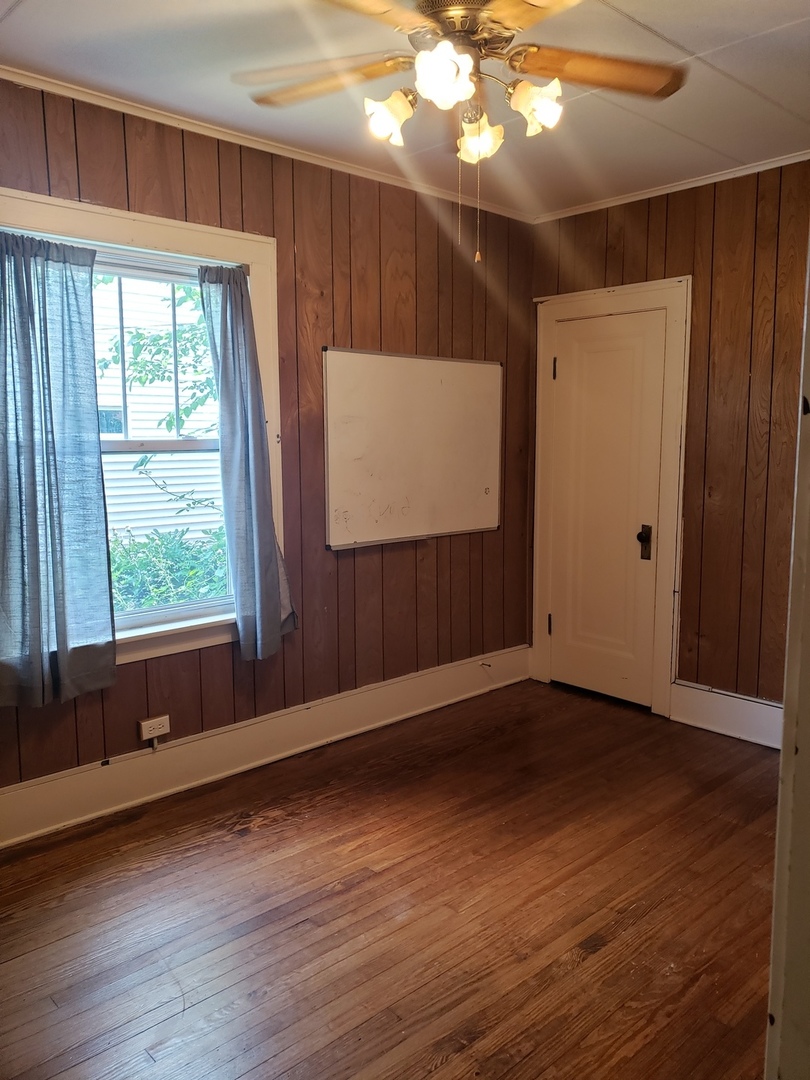 1917 Cedar Road Homewood, IL 60430 - Photo 10 of 20 a view of an empty room with wooden floor and a window