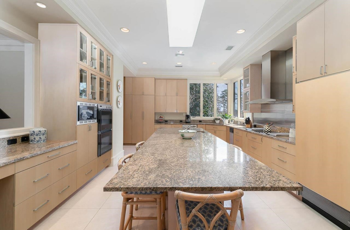 24107 Cherry Drive Chapel Hill, NC 27517 - Photo 18 of 46 a large kitchen with granite countertop a large counter top stainless steel appliances and cabinets