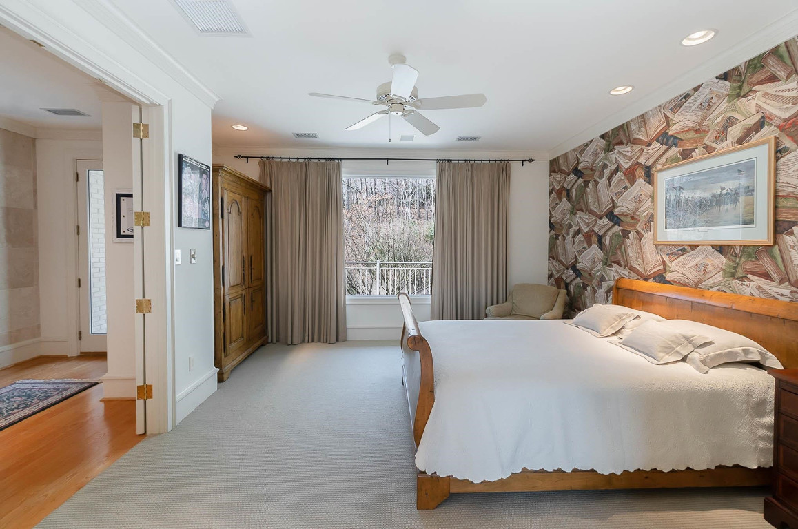 24107 Cherry Drive Chapel Hill, NC 27517 - Photo 39 of 46 a bedroom with a bed and a painting on the wall