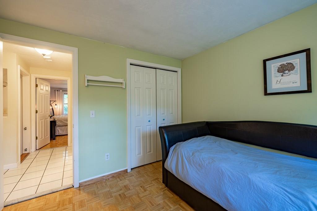 101 Shepard Road Sturbridge, MA 01566 - Photo 15 of 42 a bedroom with a bed and wooden floor