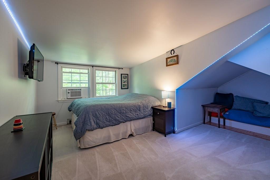 101 Shepard Road Sturbridge, MA 01566 - Photo 23 of 42 a bedroom with a large bed and a flat screen tv