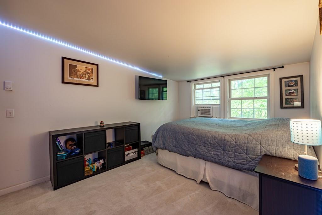 101 Shepard Road Sturbridge, MA 01566 - Photo 24 of 42 a bedroom with a bed and two windows