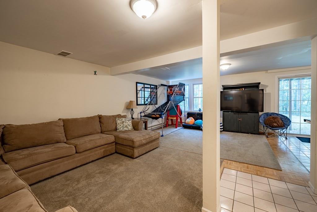 101 Shepard Road Sturbridge, MA 01566 - Photo 27 of 42 a living room with furniture and a flat screen tv