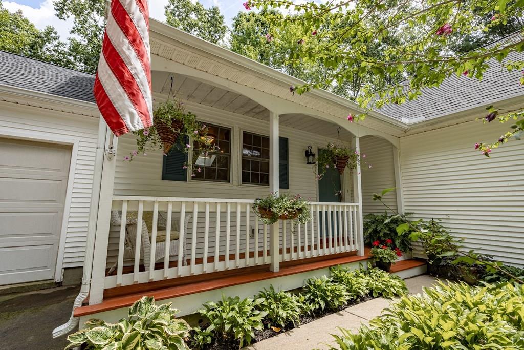 101 Shepard Road Sturbridge, MA 01566 - Photo 3 of 42 a view of a house with a small yard and flower plants