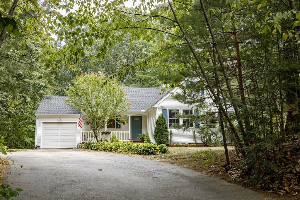 101 Shepard Road Sturbridge, MA 01566 - Photo 36 of 42 a front view of a house with a garden and trees
