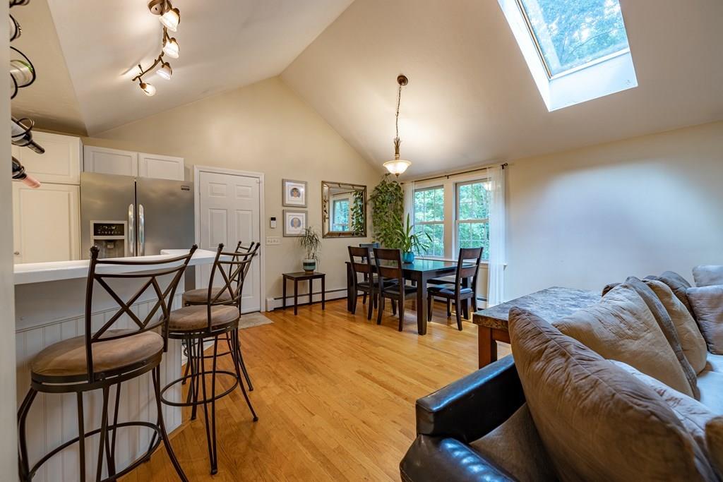 101 Shepard Road Sturbridge, MA 01566 - Photo 5 of 42 a living room with furniture a chandelier and a dining table