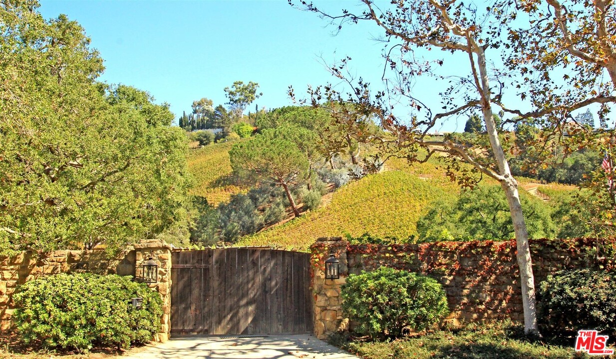 1075 Moraga Drive Los Angeles, CA 90049 - Photo 3 of 3 a view of a tree with a yard