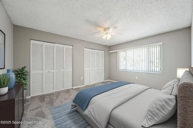 a bedroom with a large bed and a potted plant