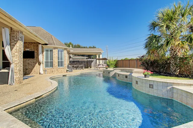 a view of a swimming pool with a patio