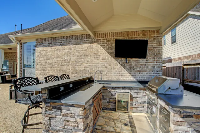 a roof deck with a couch and chairs
