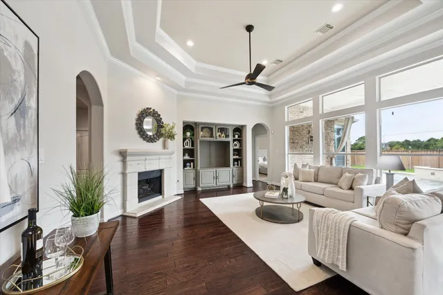 a living room with furniture a large window and a fireplace