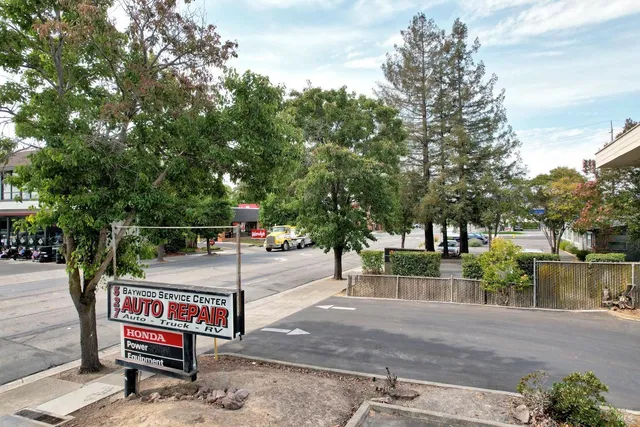 a view of a street with large trees
