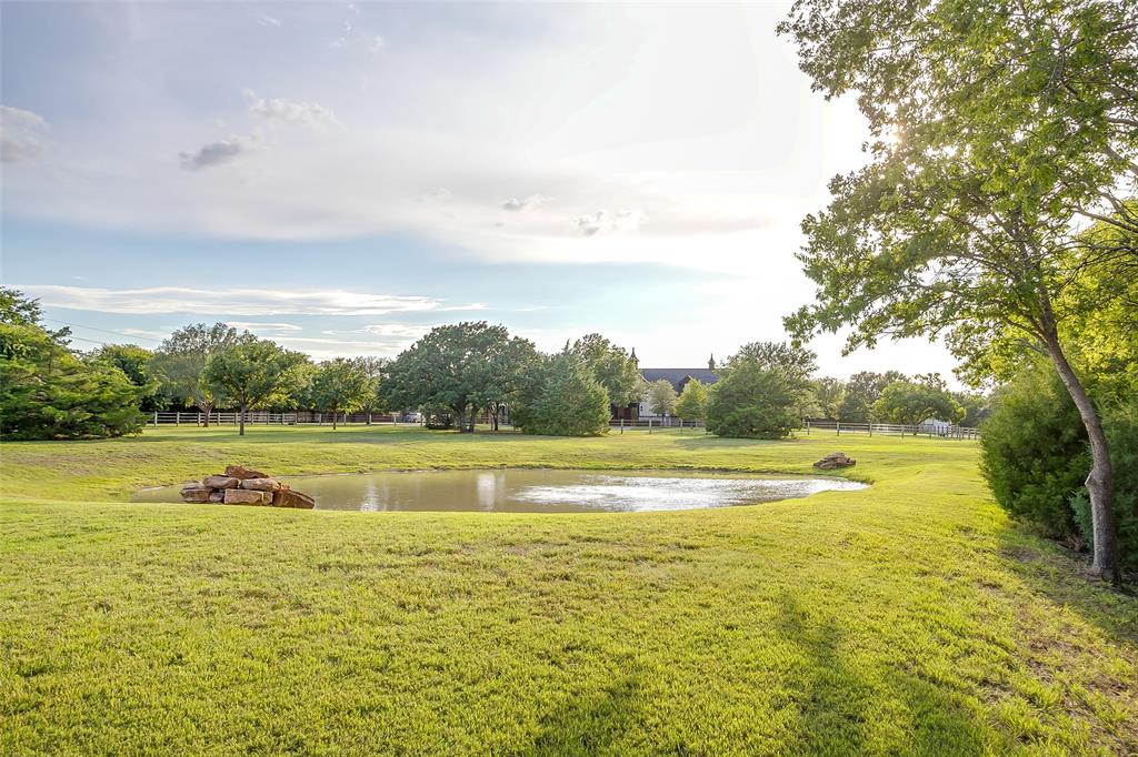 5000 T W King Road Southlake, TX 76092 - Photo 35 of 40 Still waters of the private pond, creating a peaceful focal point at the center of the property.