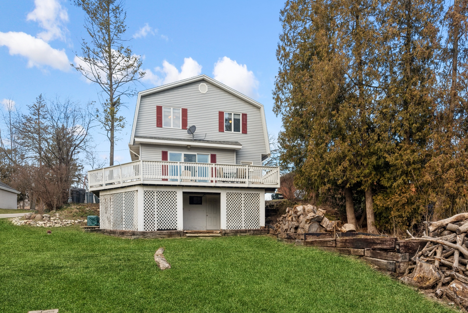 8314 Riverway Drive Cary, IL 60013 - Photo 1 of 12 a front view of a house with a garden and trees