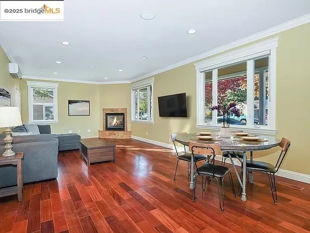 a view of a room with furniture and wooden floor