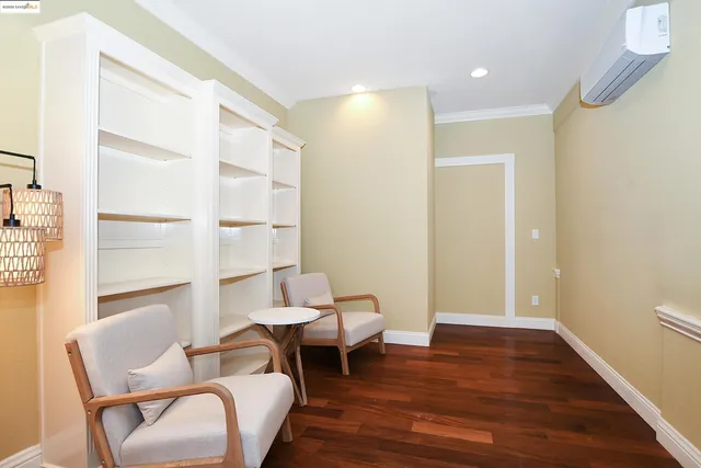 a spacious bedroom with a bed and a chandelier