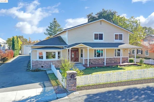 a room with furniture a potted plant and a wooden floor