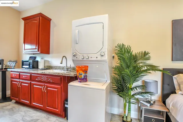 a bedroom with a large bed and a flat tv screen on a dresser