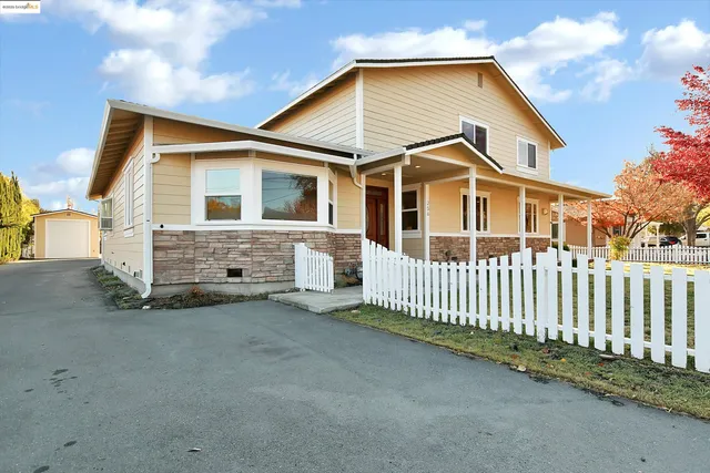 a front view of a house with a yard table and chairs