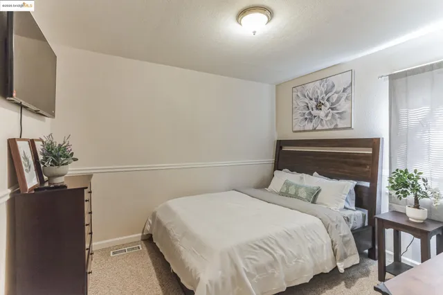 a kitchen with stainless steel appliances granite countertop a table chairs sink refrigerator and cabinets