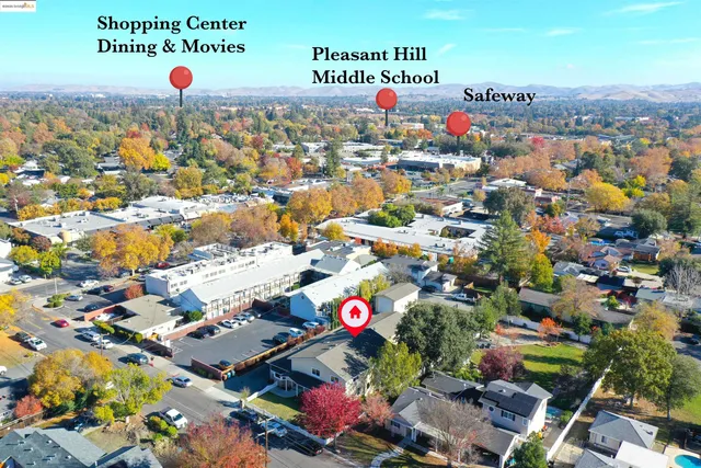 a kitchen with stainless steel appliances granite countertop a table chairs sink and cabinets