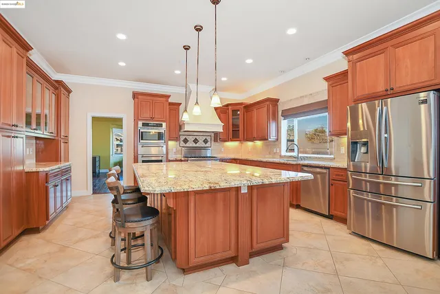 a large kitchen with a table and chairs