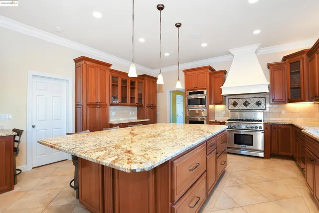 a kitchen with stainless steel appliances granite countertop a sink and cabinets