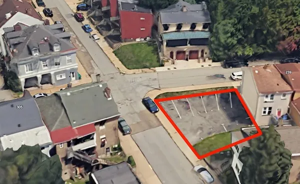 an aerial view of a houses with yard