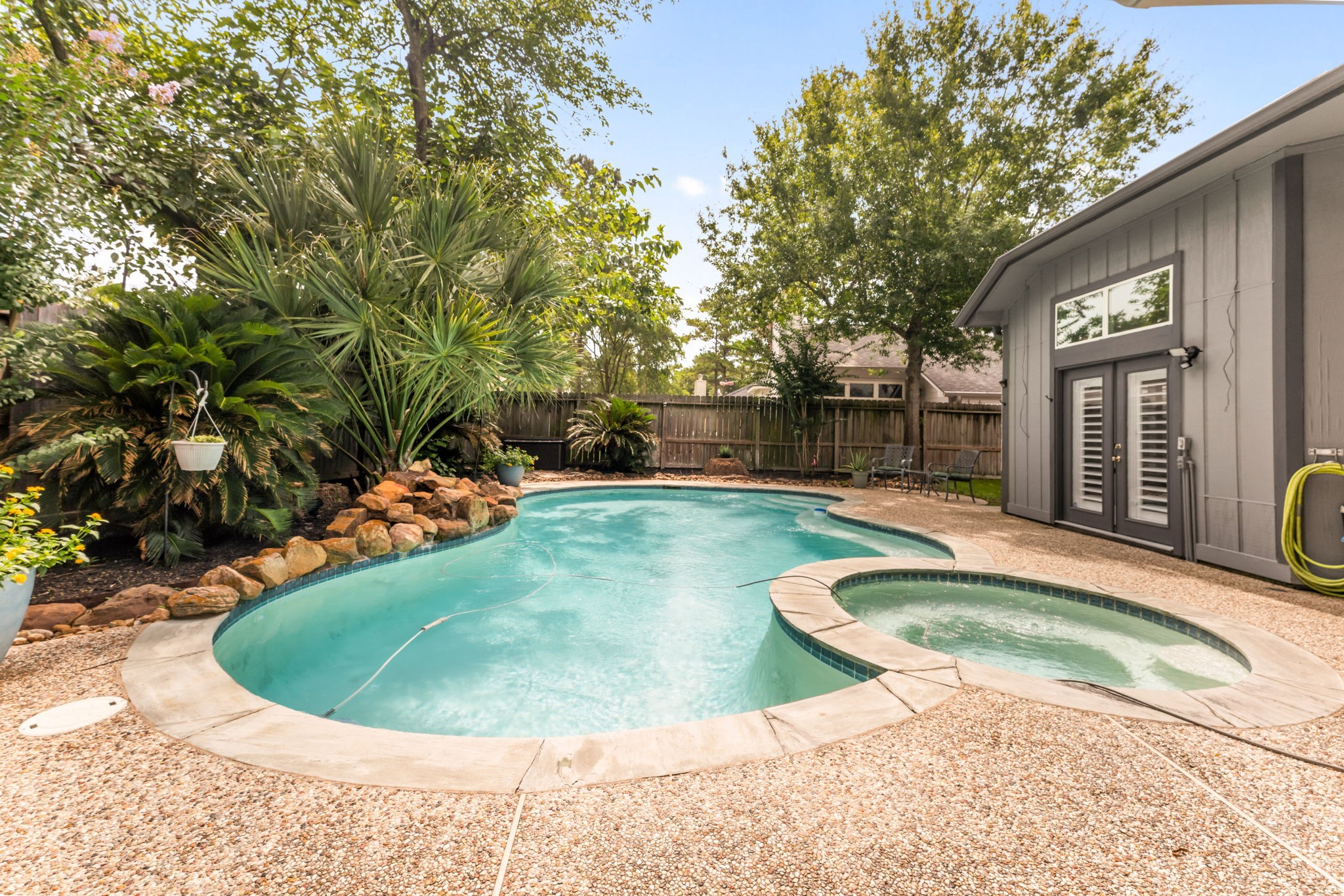 1915 Mercoal Drive Spring, TX 77386 - Photo 29 of 50 Resort-style backyard featuring a sparkling in-ground pool surrounded by mature landscaping.