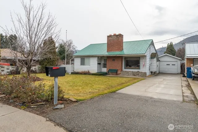 a front view of a house with a yard table and chairs