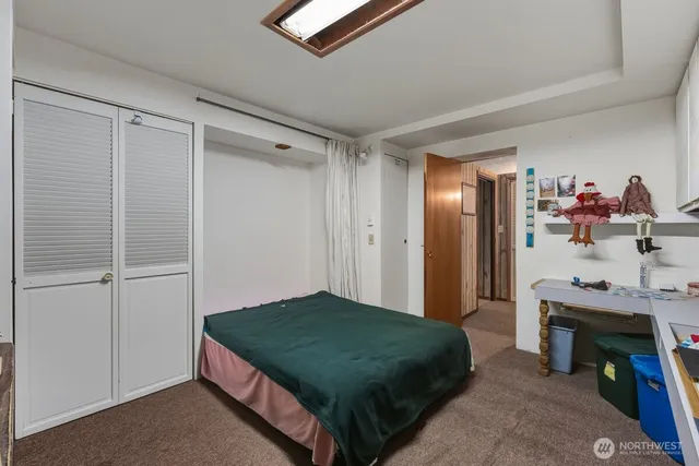 a bedroom with a bed and a fireplace