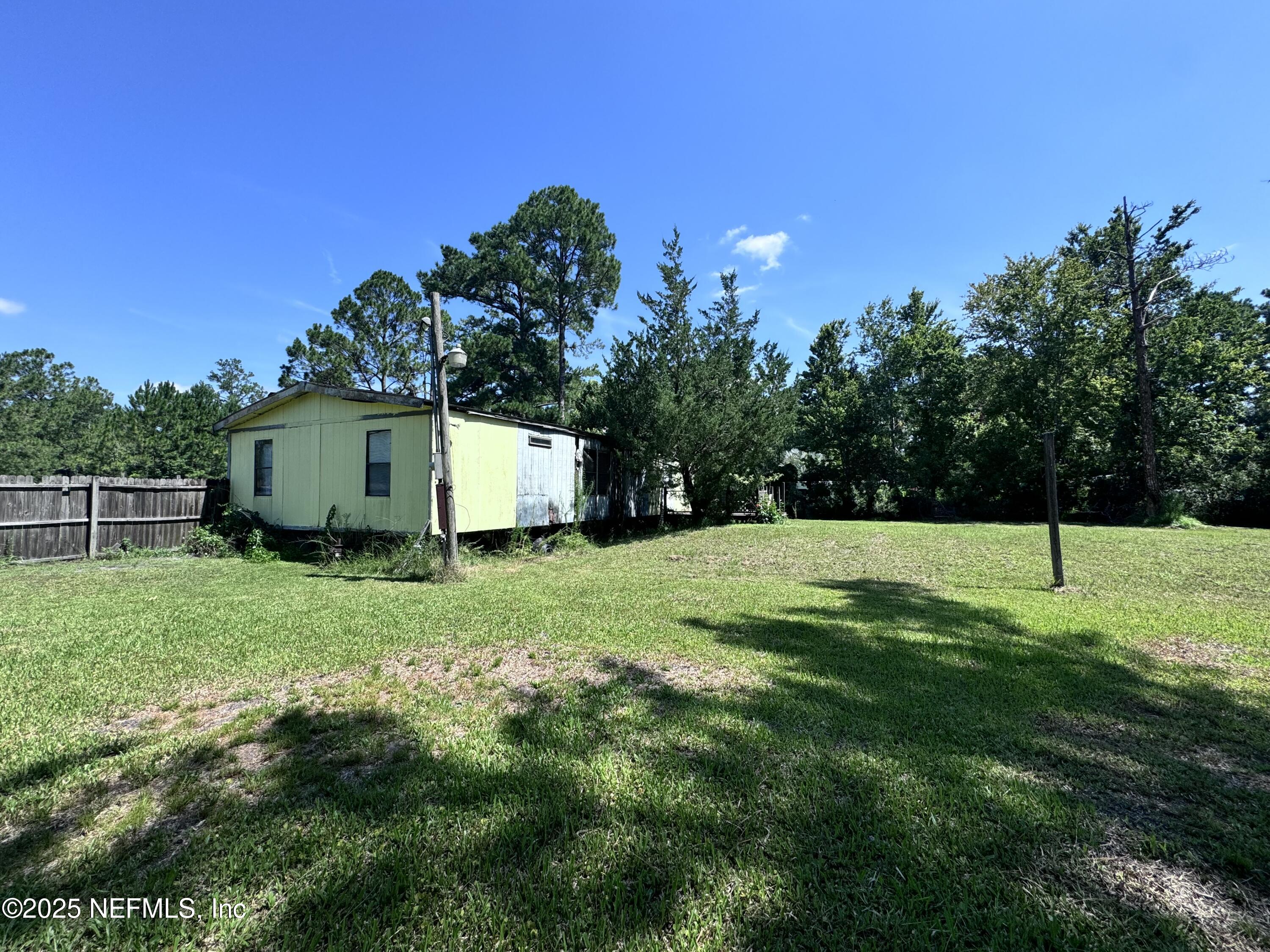 54440 Bea Road Callahan, FL 32011 - Photo 7 of 7 a view of a backyard with large trees
