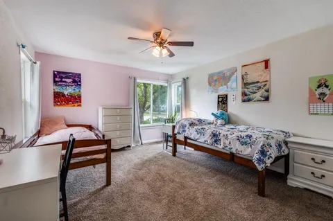 a bedroom with a bed and a chandelier