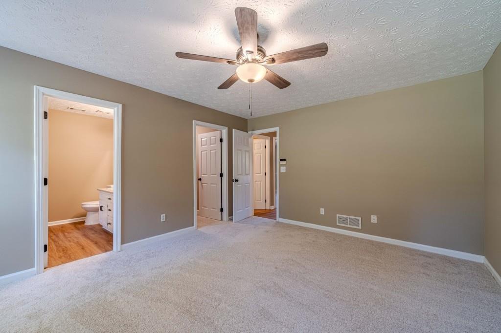 701 Woodland Ridge Drive Monroe, GA 30656 - Photo 21 of 39 a view of a room with a ceiling fan and bathroom