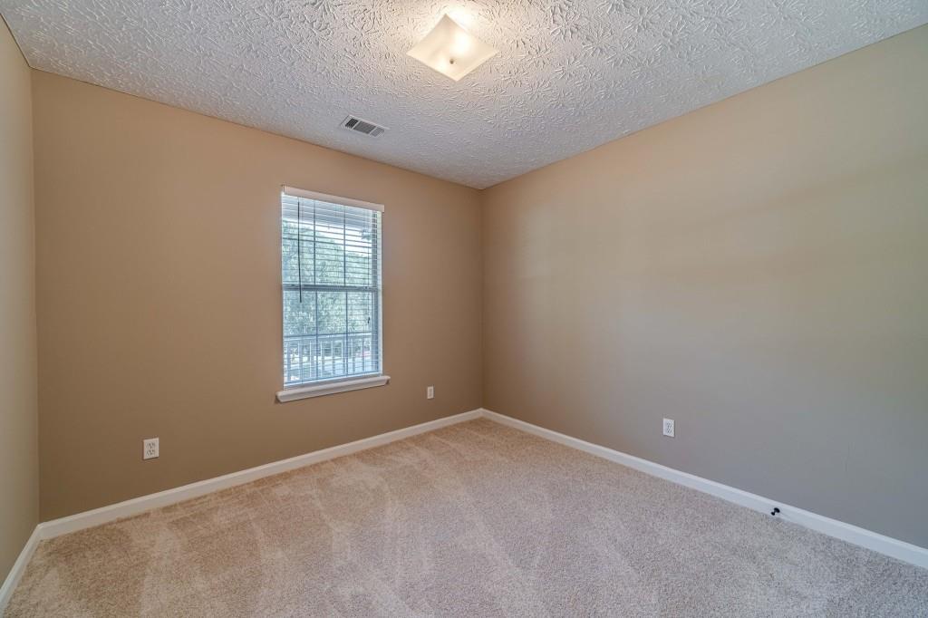 701 Woodland Ridge Drive Monroe, GA 30656 - Photo 28 of 39 an empty room with a window
