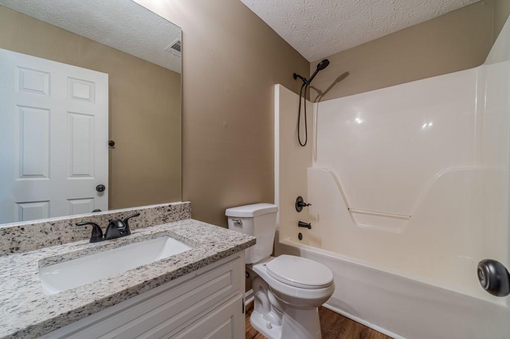 701 Woodland Ridge Drive Monroe, GA 30656 - Photo 29 of 39 a bathroom with a granite countertop sink toilet and shower
